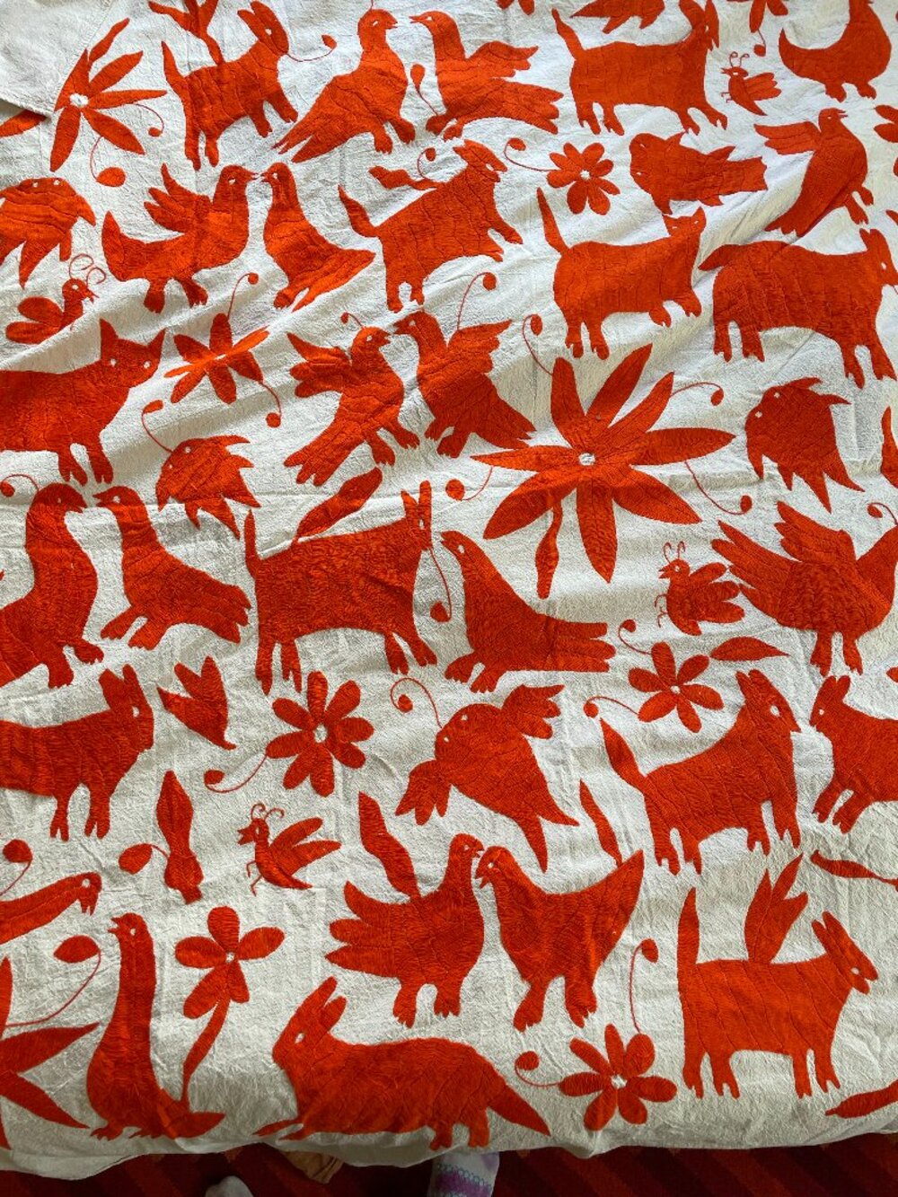 Hand embroidered orange otomi Mexican coverlet with animals